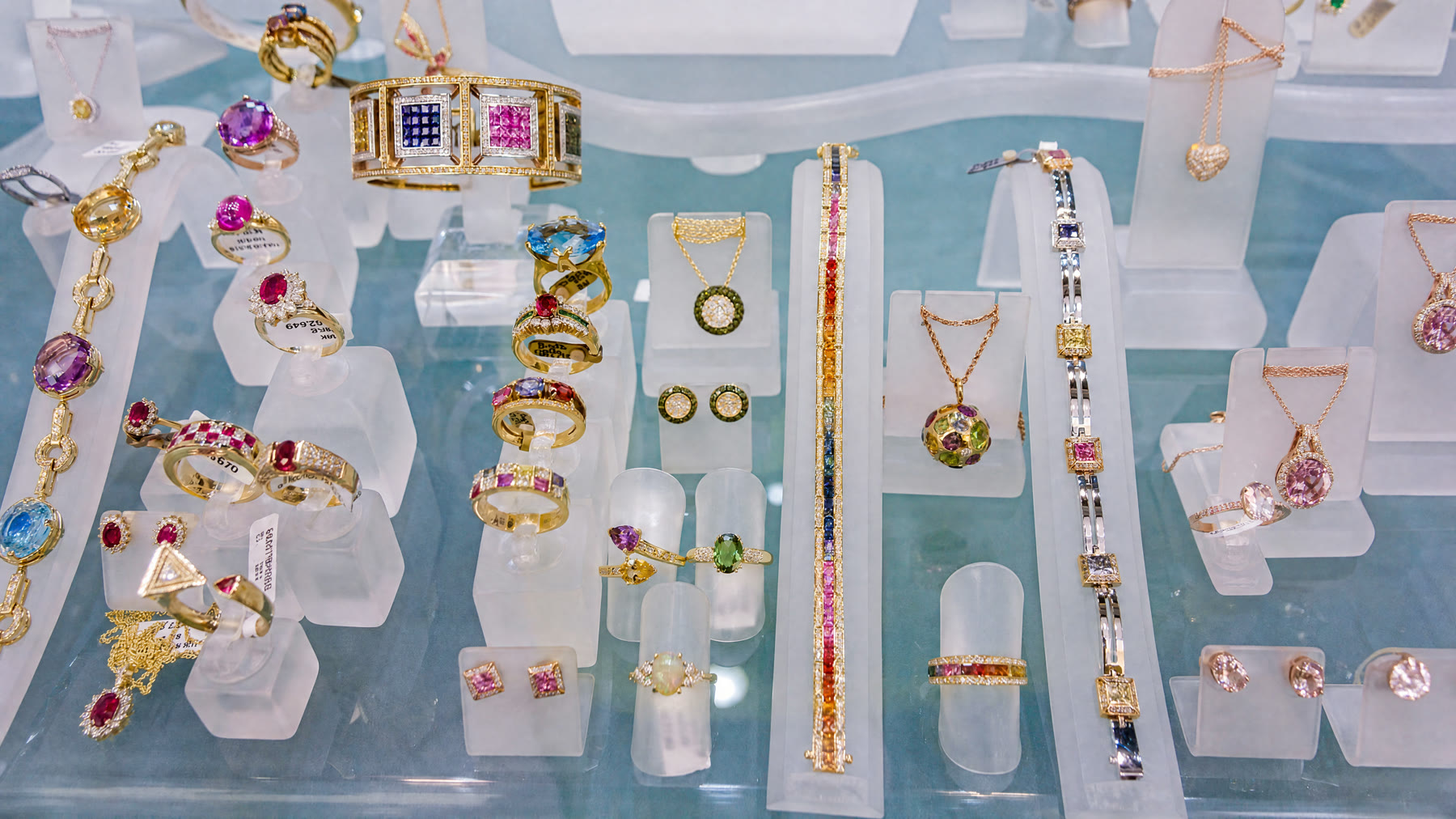 A display case of gemstone rings, bracelets and necklaces at Aung Jewelry