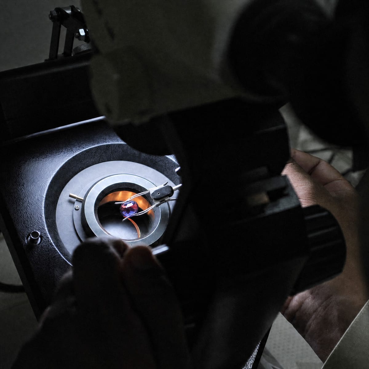 A sapphire examined under a gemological instrument in the lab