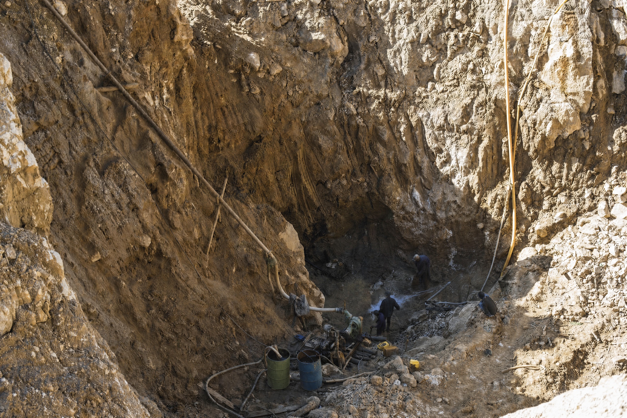 Miners working at the bottom of a deep open-pit gem mine in Mogok